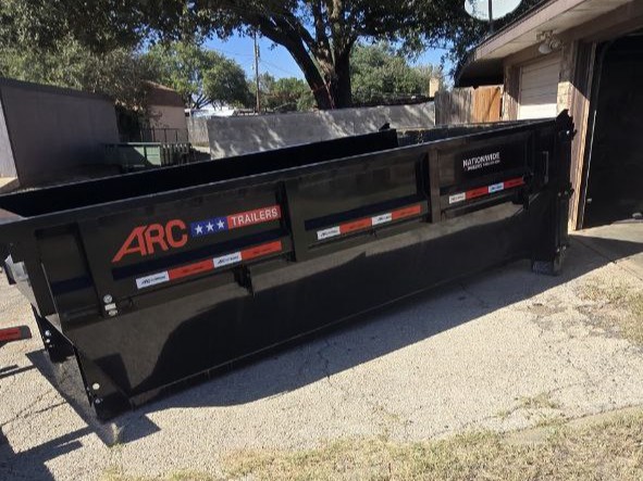 SD Services trash trailer staged on a jobsite lot.